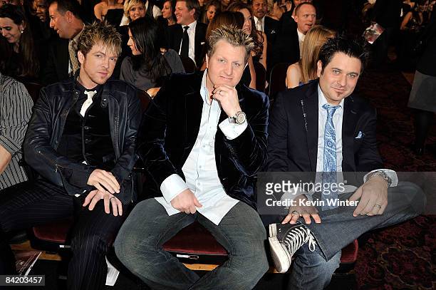 Musicians Joe Don Rooney, Gary LeVox, and Jay DeMarcus from the country band Rascal Flatts pose in the audience during the 35th Annual People's...