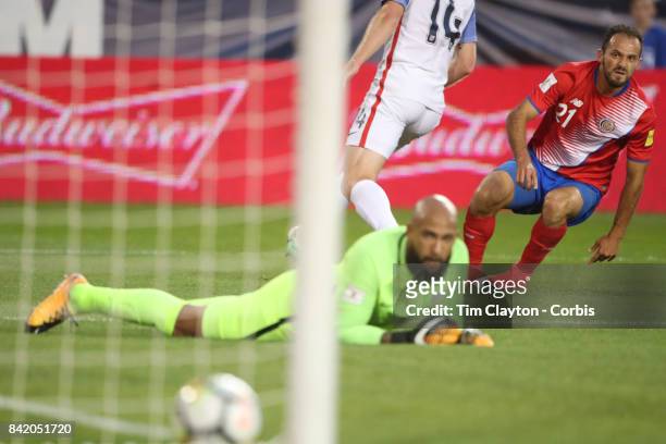 Marcos Urena of Costa Rica scores in the first half as he beats goalkeeper Tim Howard of the United States and defender Tim Ream of the United States...