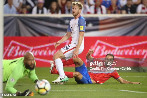 Marcos Urena of Costa Rica scores in the first half as he beats goalkeeper Tim Howard of the United States and defender Tim Ream of the United States...