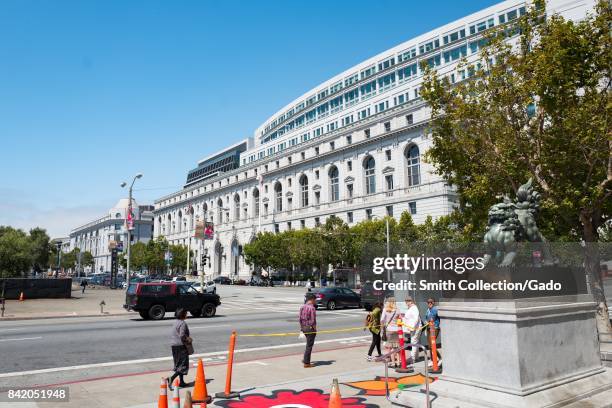 Supreme Court of California in the Civic Center neighborhood of San Francisco, California, with people walking past and Flower Power designs painted...