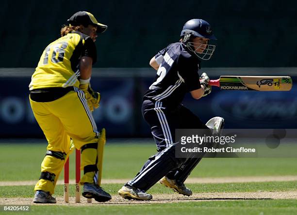 Jessica Cameron of the Spirit plays a shot as Fury wicketkeeper Jenny Wallace looks on during the WNCL match between the Victoria Spirit and the...