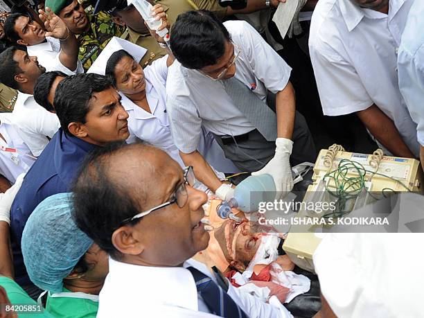 Doctors treat Sri Lankan newspaper editor Lasantha Wickrematunga as he is rushed to the Colombo South hospital after being shot by unidentified...