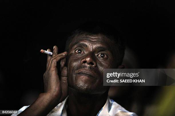 Supporter of Malaysia's opposition leader Anwar Ibrahim listens to his speech at a by-election rally in the northeastern Terengganu state on January...