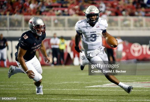 Quarterback Caylin Newton of the Howard Bison runs against defense lineman Mark Finau of the UNLV Rebels during their game at Sam Boyd Stadium on...