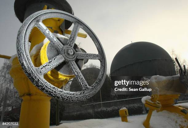 The rotary handle to a valve stands frozen over a natural gas pipe leading to spherical gas containers at a natural gas storage facility of local gas...