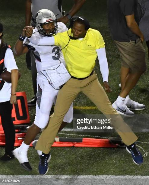Quarterback Caylin Newton of the Howard Bison celebrates with wide receivers coach Mike London Jr. After Newton scored a four-yard rushing touchdown...