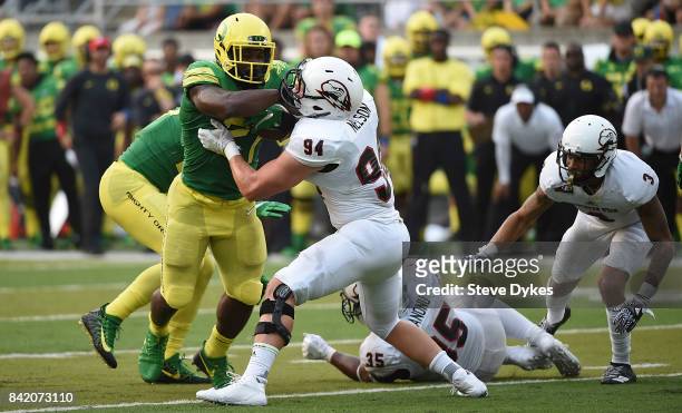 Running back Royce Freeman of the Oregon Ducks stands up linebacker Taylor Nelson of the Southern Utah Thunderbirds as he runs for a first down in...