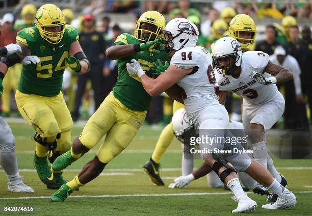 Running back Royce Freeman of the Oregon Ducks stands up linebacker Taylor Nelson of the Southern Utah Thunderbirds as he runs for a first down in...