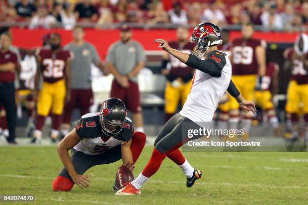 Zack Hocker of the Bucs kicks a field goal from the hold of Bryan Anger during the NFL Preseason game between the Washington Redskins and the Tampa...