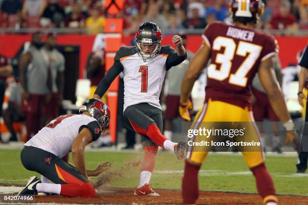 Zack Hocker of the Bucs attempts a field goal from the hold of Bryan Anger but gets too much turf and misses during the NFL Preseason game between...