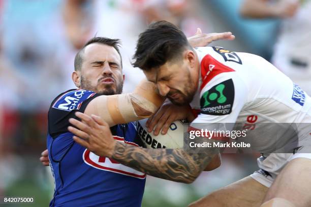 Josh Reynolds is tackled by Gareth Widdop of the Dragons during the round 26 NRL match between the St George Illawarra Dragons and the Canterbury...
