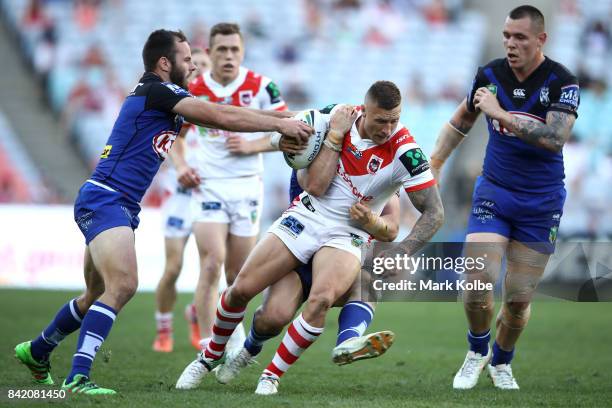 Tariq Sims of the Dragons is tackled during the round 26 NRL match between the St George Illawarra Dragons and the Canterbury Bulldogs at ANZ Stadium...