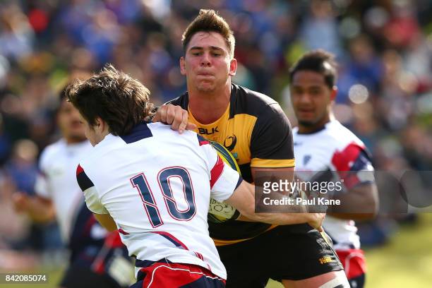 Richard Hardwick gets tackled by Jack McGregor of the Rising during the round one NRC match between Perth Spirit and Melbourne Rising at McGillivray...