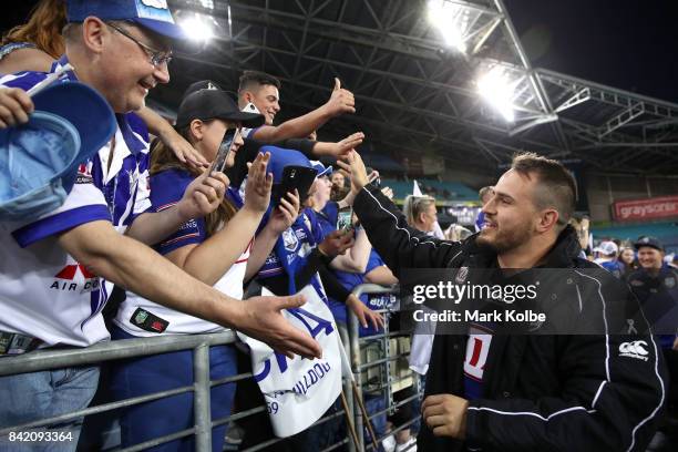 Josh Reynolds of the Bulldogs shakes hands with the crowd after victory during the round 26 NRL match between the St George Illawarra Dragons and the...