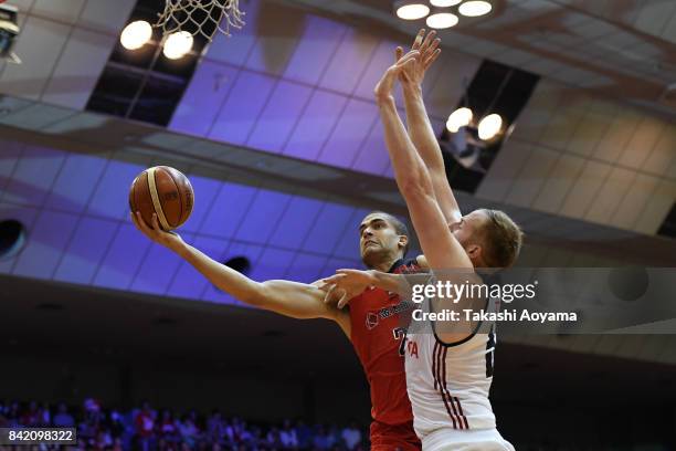 Gavin Edwards of the Chiba Jets shoots while under pressure from Alex Kirk of Alvark Tokyo during the B.League Kanto Early Cup final between Alvark...