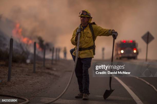 Firefighter holds a hose on the 120 freeway during the La Tuna Fire on September 2, 2017 near Burbank, California. Los Angeles Mayor Eric Garcetti...