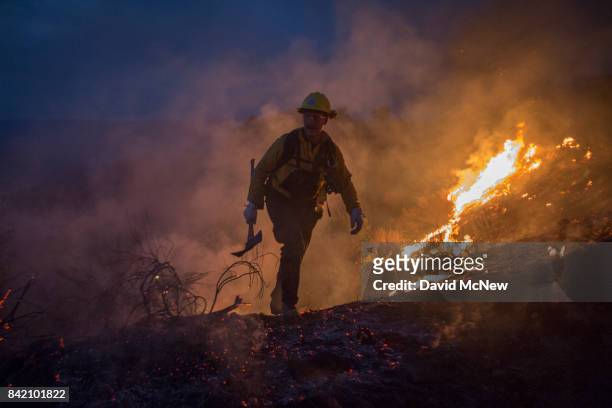 Firefighters use hand tools in chaparral brush to fight the La Tuna Fire on September 2, 2017 near Burbank, California. Los Angeles Mayor Eric...