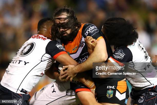 Aaron Woods of the Tigers is tackled during the round 26 NRL match between the Wests Tigers and the New Zealand Warriors at Leichhardt Oval on...