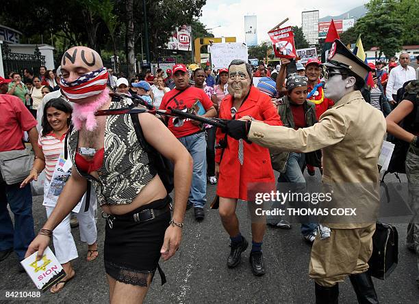 Venezuelan actors dressed up as Adolf Hitler , US President George W Bush and a prostitute --as the UN-- perform during a demonstration in front of...