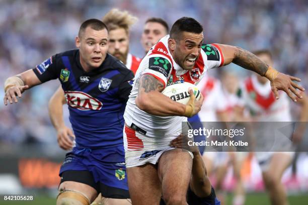 Paul Vaughan of the Dragons is tackled by David Klemmer and Moses Mbye of the Bulldogs during the round 26 NRL match between the St George Illawarra...