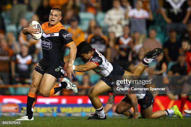 Tuimoala Lolohea of the Tigers makes a break during the round 26 NRL match between the Wests Tigers and the New Zealand Warriors at Leichhardt Oval...