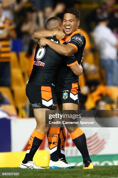 Tuimoala Lolohea of the Tigers celebrates scoring a try with Esan Nike Marsters of the Tigers during the round 26 NRL match between the Wests Tigers...