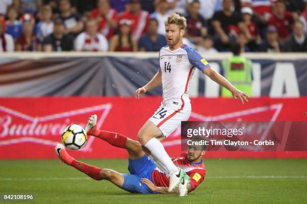Marcos Urena of Costa Rica scores in the first half as he beats goalkeeper Tim Howard of the United States and defender Tim Ream of the United States...