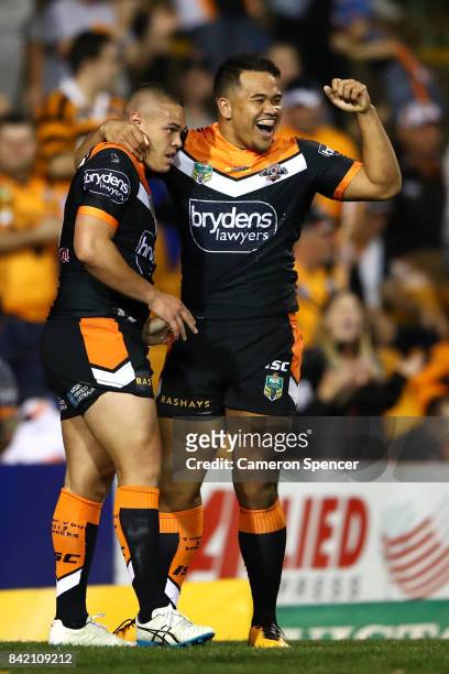 Tuimoala Lolohea of the Tigers celebrates scoring a try with Esan Nike Marsters of the Tigers during the round 26 NRL match between the Wests Tigers...