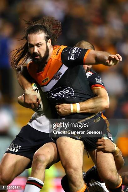 Aaron Woods of the Tigers is tackled during the round 26 NRL match between the Wests Tigers and the New Zealand Warriors at Leichhardt Oval on...