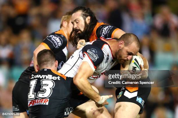 Simon Mannering of the Warriors is tackled during the round 26 NRL match between the Wests Tigers and the New Zealand Warriors at Leichhardt Oval on...