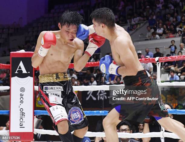 World Boxing Association super bantamweight champion Shun Kubo of Japan receives a punch from US challenger Daniel Roman during their title bout in...