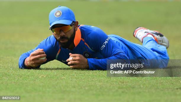 Indian captain Virat Kohli takes the catch to dismiss Sri Lanka's Dilshan Munaweera during the final one day international cricket match between Sri...