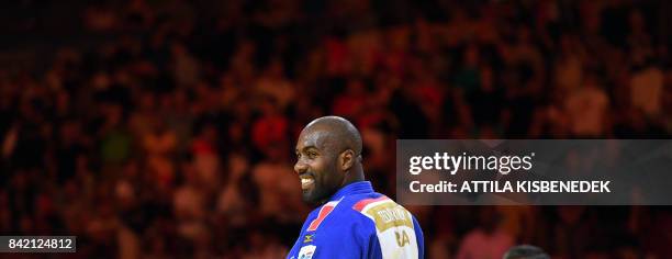 Gold medalist France's Teddy Riner celebrates after winning the final of mens +100kg category at the World Judo Championships in Budapest on...