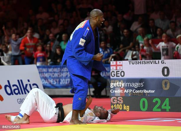 France's Teddy Riner celebrates as he competes with Georgia's Guram Tushishvili in their semi-final match of the mens +100kg category at the World...