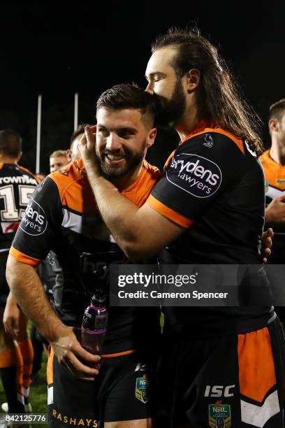 Aaron Woods of the Tigers embraces team mate James Tedesco of the Tigers after winning the round 26 NRL match between the Wests Tigers and the New...