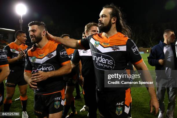 Aaron Woods of the Tigers embraces team mate James Tedesco of the Tigers after winning the round 26 NRL match between the Wests Tigers and the New...