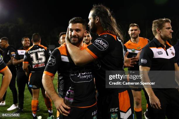 Aaron Woods of the Tigers embraces team mate James Tedesco of the Tigers after winning the round 26 NRL match between the Wests Tigers and the New...