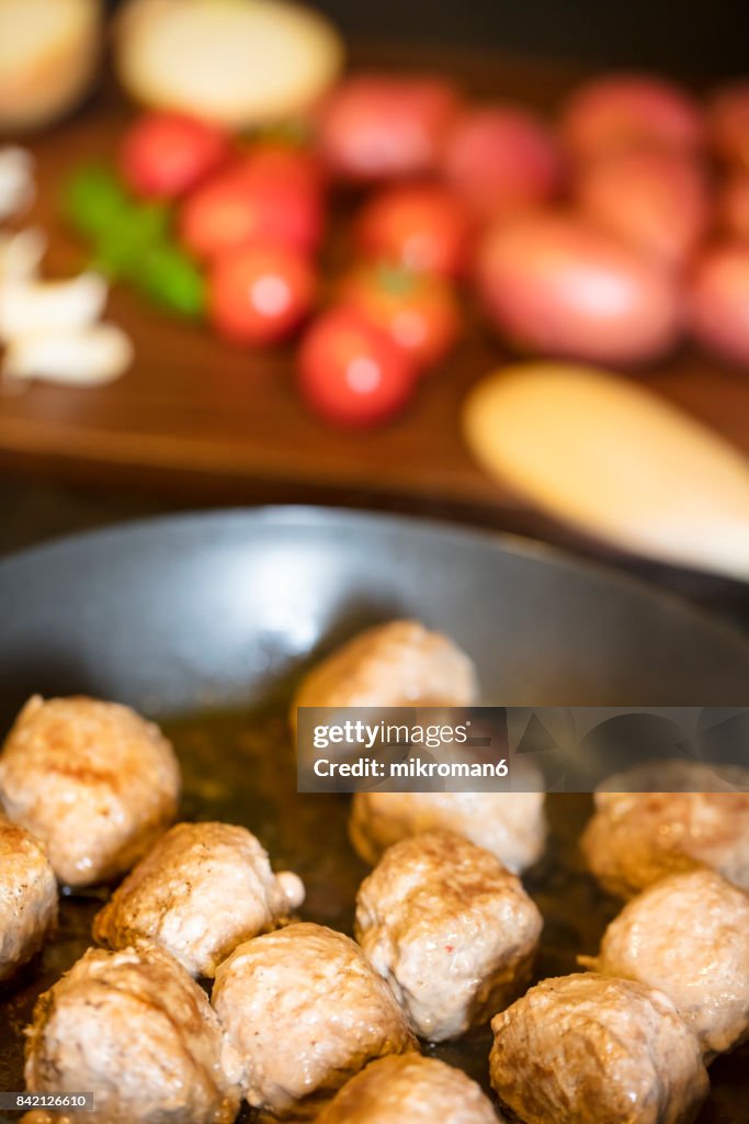 Close-Up Of Meatballs In frying pan on hot Electric Hob