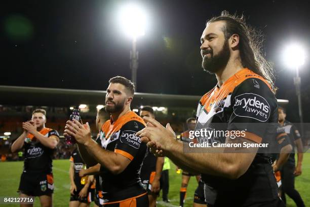 Aaron Woods of the Tigers and team mate James Tedesco of the Tigers thank fans after winning the round 26 NRL match between the Wests Tigers and the...