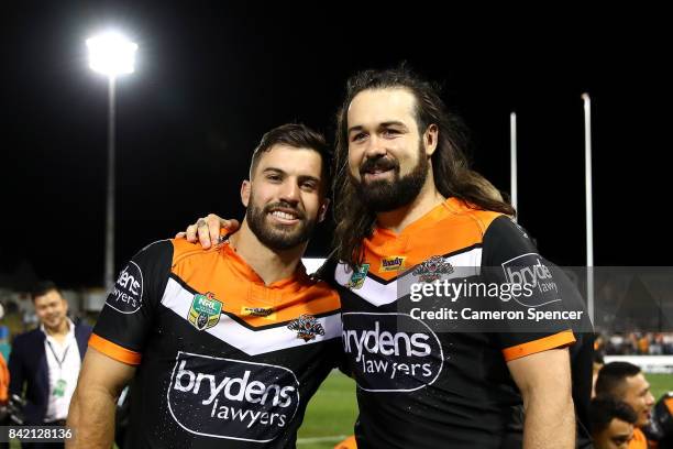 James Tedesco of the Tigers poese with Aaron Woods of the Tigers following their final game with the Tigers during the round 26 NRL match between the...