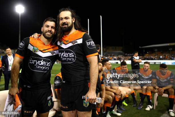 James Tedesco of the Tigers poese with Aaron Woods of the Tigers following their final game with the Tigers during the round 26 NRL match between the...