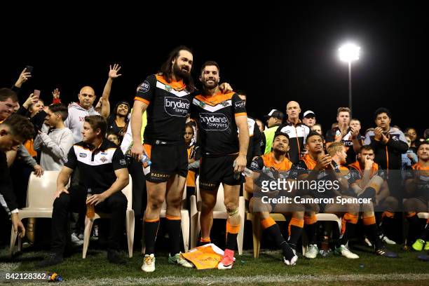 James Tedesco of the Tigers poese with Aaron Woods of the Tigers following their final game with the Tigers during the round 26 NRL match between the...
