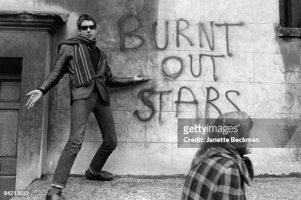Shane MacGowan of The Nips poses next to graffiti that reads 'Burnt Out Stars' in London's Soho neighborhood, 1981.