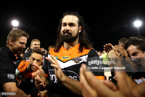 Aaron Woods of the Tigers is applauded as he leaves the field after playing his final game for the Tigers during the round 26 NRL match between the...