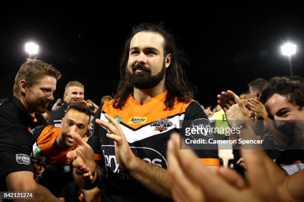 Aaron Woods of the Tigers is applauded as he leaves the field after playing his final game for the Tigers during the round 26 NRL match between the...