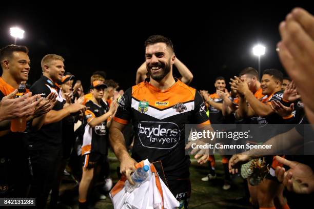 James Tedesco of the Tigers is applauded off the field after playing his final game for the Tigers during the round 26 NRL match between the Wests...