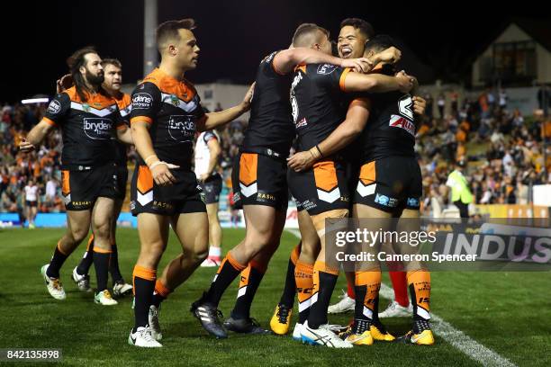 David Nofoaluma of the Tigers celebrates a try with team mates during the round 26 NRL match between the Wests Tigers and the New Zealand Warriors at...