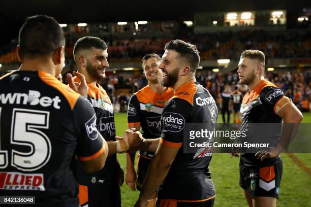 James Tedesco of the Tigers shares a laugh with team mates during the round 26 NRL match between the Wests Tigers and the New Zealand Warriors at...