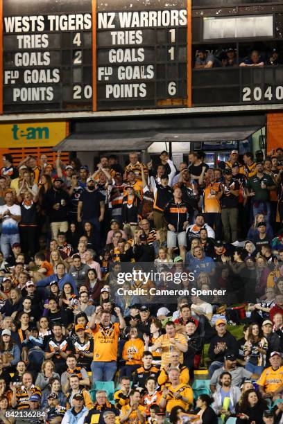 Wests Tigers fans celebrate a try during the round 26 NRL match between the Wests Tigers and the New Zealand Warriors at Leichhardt Oval on September...