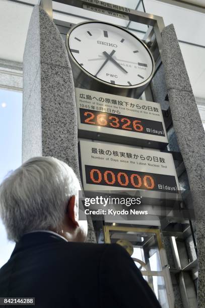 Kenji Shiga, director of the Hiroshima Peace Memorial Museum, looks at a "peace clock" monument on Sept. 3 at the museum in the city of Hiroshima,...